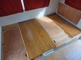 a bed that has been built into the side of a boat