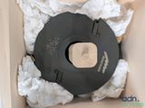 a cardboard box with a black lid and a piece of paper in it