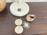 a small vase with coins and a pair of rings on it