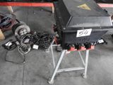 a black box sitting on top of a stand in a garage