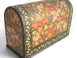 a small wooden box with a floral design on it