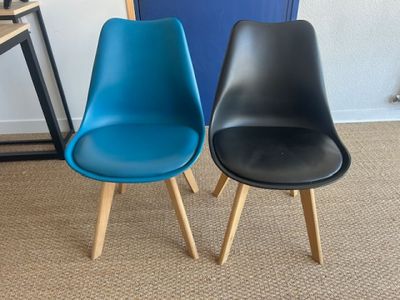 pair of black and blue chairs with wooden legs on carpeted floor