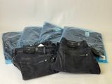 three pairs of black jeans sitting on top of each other