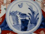 a decorative plate with a blue and red design on it