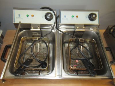 two deep fryers sitting side by side on a table