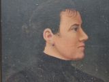 portrait of a man in a black shirt and a black collared shirt