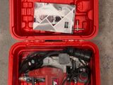 the tools are in the red case on the concrete floor