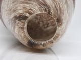 a close up view of a vase with a curved handle