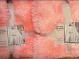 several pink and white teddy bears are on display in a store