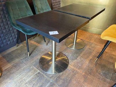 tables and chairs in a restaurant with a price tag on the table