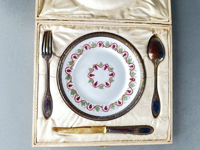 a plate and fork in a box with a spoon and fork