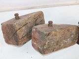two pieces of wood sitting on a table next to a chess piece