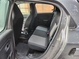 a dirty car with the door open and the seat down