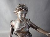a statue of a woman holding a tennis racquet