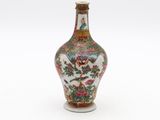 an image of a small vase with a bird and flowers on it