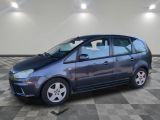 a picture of a small blue car parked in a garage