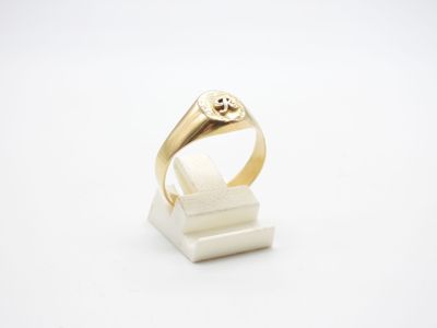 a close up of a gold ring on a white surface