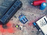 a drawing of a skull on the ground next to a radio and batteries