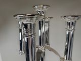 two silver candles that are sitting on a table