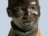 statue of a young boy with a scarf on his neck