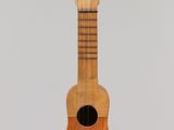 an image of a wooden ukulele hanging from a string