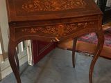 a small desk with a drawer on top of it