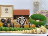 a lot of assorted jewelry on a white table