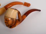 a picture of a pipe with a man ' s head on it