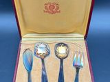 four spoons and a fork in a case