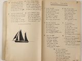 an open book with a drawing of a sailboat on it