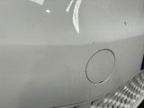 a close up of a car ' s front bumper with a hole in it