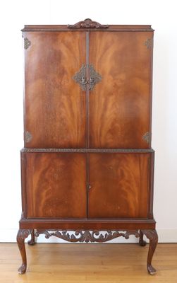 an image of a wooden cabinet sitting on top of a hard wood floor