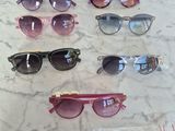 several pairs of sunglasses on a table with a price tag
