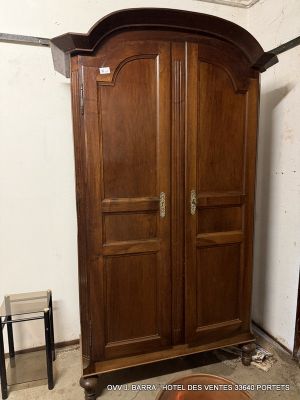 a large wooden armoire in the corner of a room