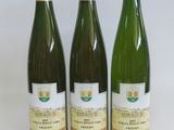 three bottles of wine sitting on a table next to each other