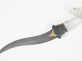 a small knife with a green handle on a white surface
