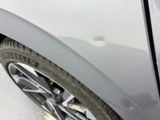 a close up view of a car ' s front wheel and tire