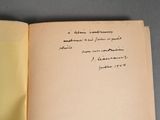 an open book with writing on it sitting on top of a table
