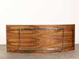 a close up of a wooden table with a metal frame on it