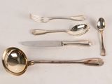 a lot of silverware on a table with a spoon and a knife