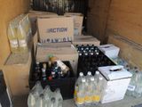 many bottles of water sitting on the floor next to boxes