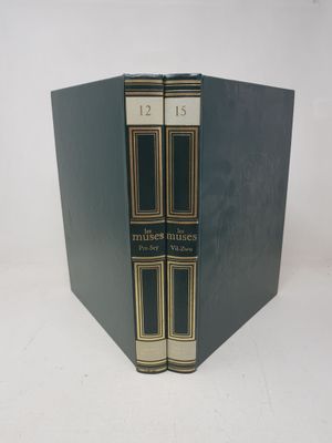 two books are stacked on top of each other on a white surface