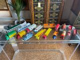 a lot of toy trains on the table in the room
