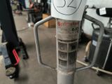 a pole with a sticker on it in a garage