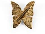 a gold plated butterfly brooch with a bar in the middle