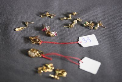 a lot of small gold studs and a price tag on a table