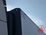 a white truck with a blue logo on the side of it