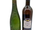 two bottles of wine sitting next to each other on a white surface