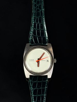 an image of a close up of a wrist watch on a black surface