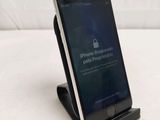 a cell phone that is sitting on top of a stand